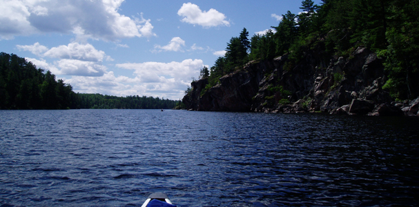  paddling past towering cliffs