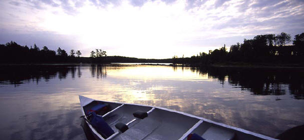 launching a canoe at sunset