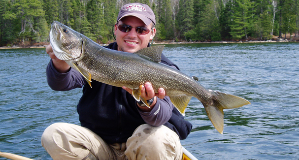 Above: fishing guide showing off a decent lake trout